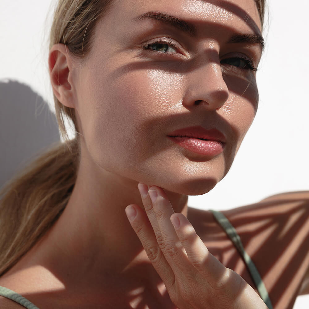 Beautiful woman with flawless skin in shadow