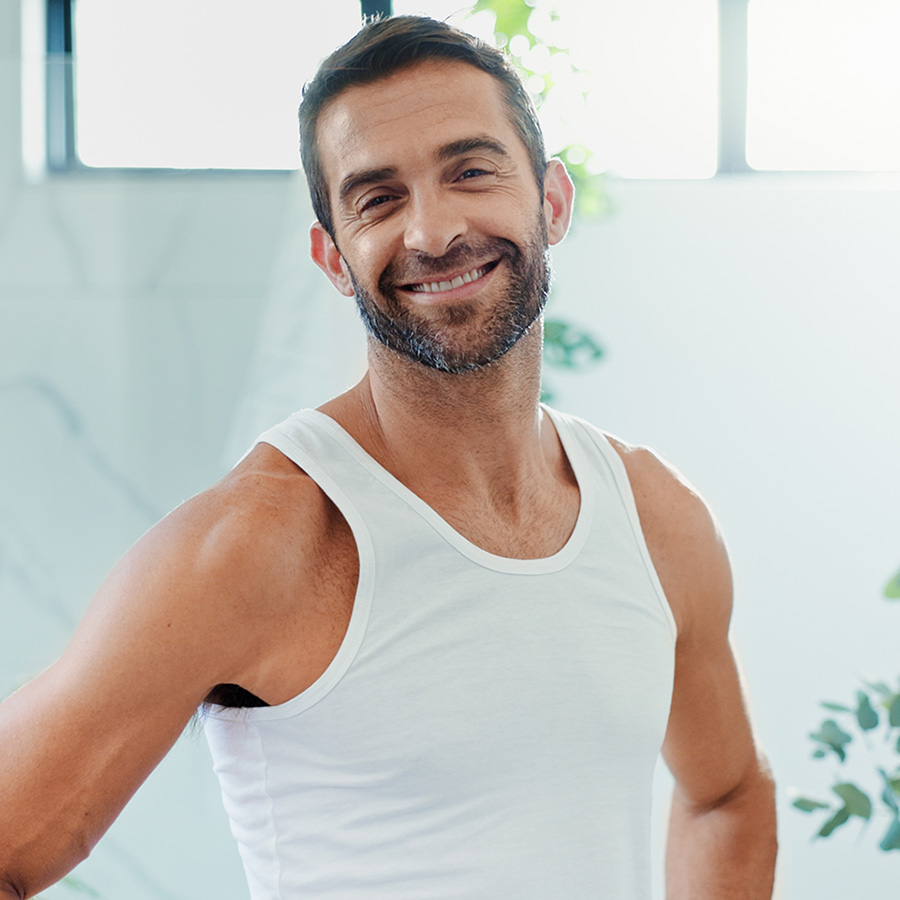 a fit man in a white undershirt