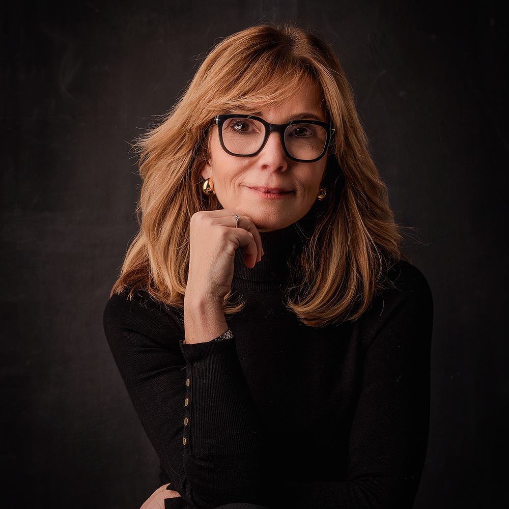 Mature woman with red hear and a black shirt