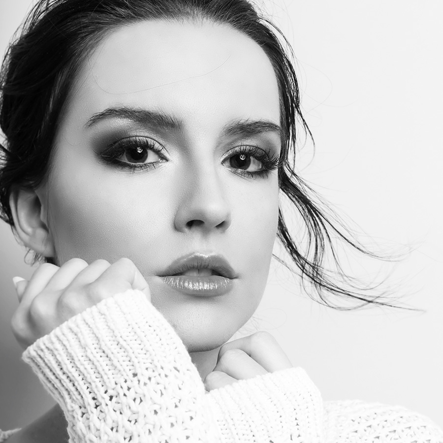 Beautiful young woman in a white sweater