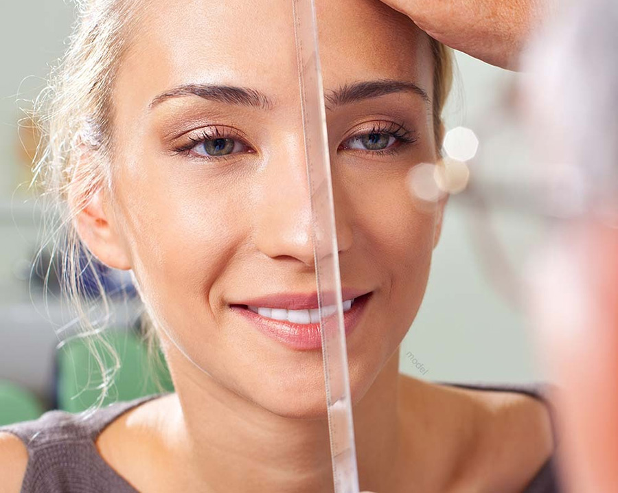 A young woman having her nose inspected