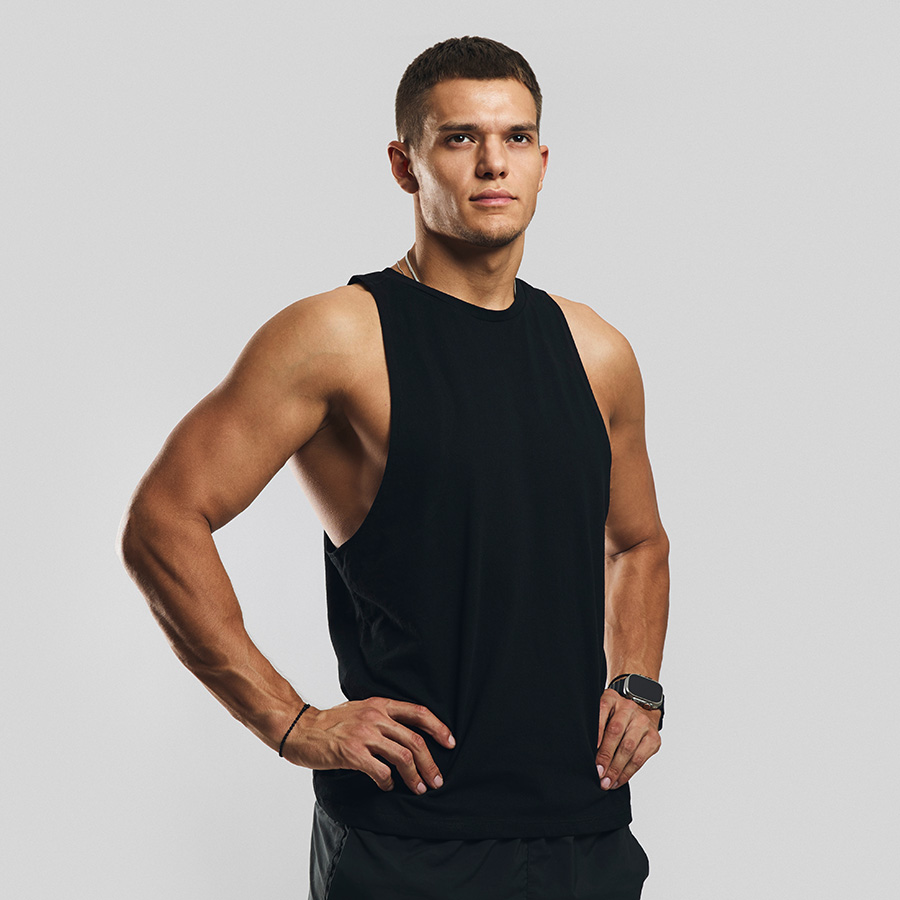 Profile of a fit man in a black sleeveless shirt